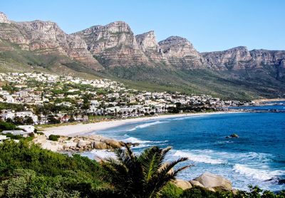 High angle view of townscape by sea against sky