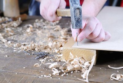 Close-up of hands working on table