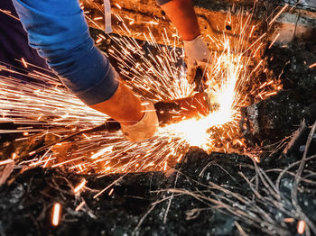 Low angle view of man working on fire