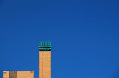 Low angle view of built structure against clear blue sky