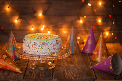 Close-up of illuminated candles on table