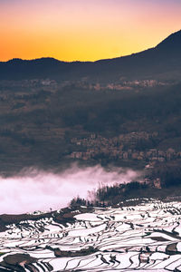 Scenic view of snowcapped mountains against sky during sunset