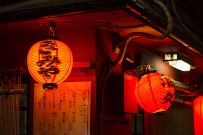 Low angle view of illuminated lanterns hanging at night