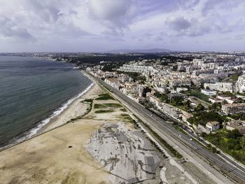 High angle view of beach and buildings against sky