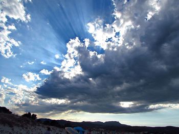 Scenic view of mountains against cloudy sky