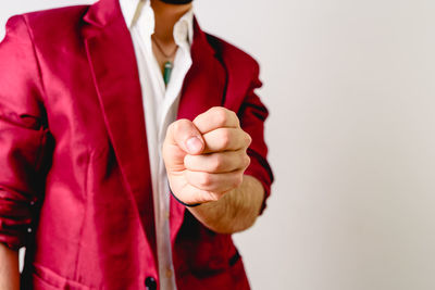 Midsection of man standing against white background