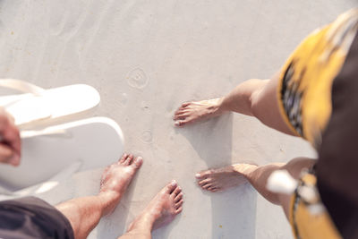 Top view of couples feet enjoying the powdery white sand of boracay, philippines.