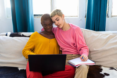 Young woman using laptop at home