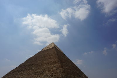 Low angle view of historical building against cloudy sky