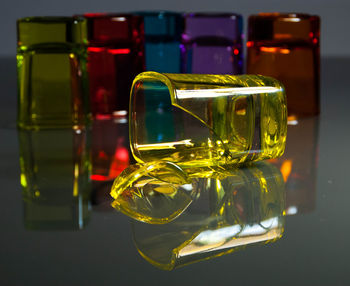 Close-up of broken yellow glass on bar counter at nightclub