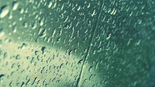 Full frame shot of raindrops on window