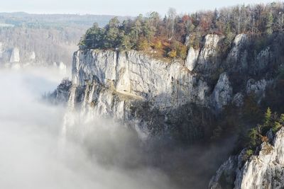 Scenic view of cliff in foggy weather