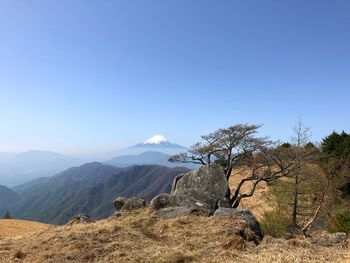 Scenic view of mountains against clear blue sky