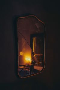 Close-up of illuminated car against black background