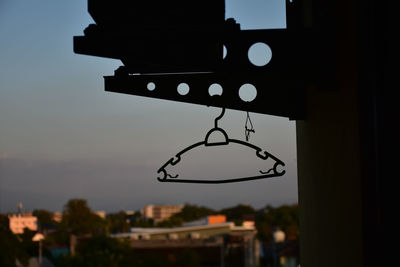 Low angle view of illuminated lamp post against building