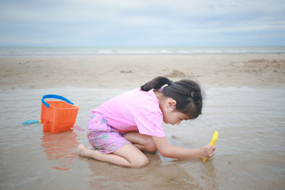 Cute girl on beach by sea