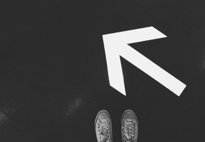 Low section of person standing on tiled floor