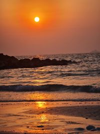 Scenic view of sea against orange sky during sunset
