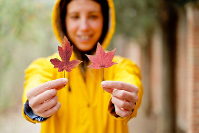 Smiling woman holding leaves