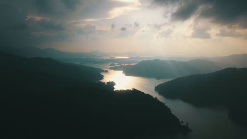 High angle view of silhouette mountains against sky during sunset