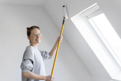 Midsection of woman holding thermometer