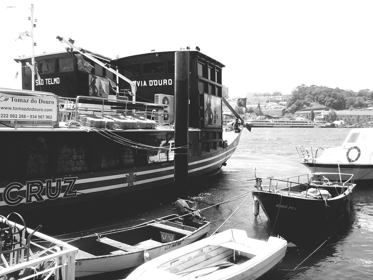 transportation, nautical vessel, mode of transport, boat, moored, water, clear sky, built structure, river, architecture, bridge - man made structure, day, travel, harbor, building exterior, waterfront, canal, outdoors, sky, no people