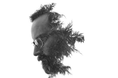 Double exposure image of man and tree against white background