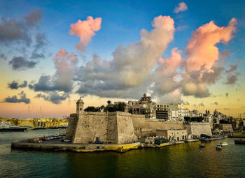 Panoramic view of river and buildings against sky