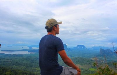 Man looking at mountains against sky