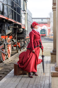 Rear view of woman standing in train