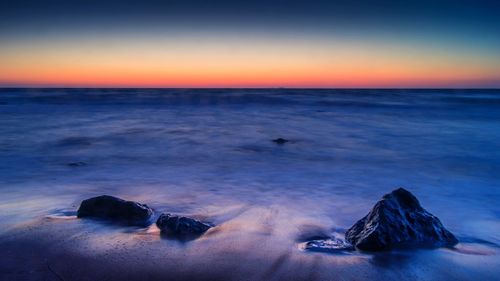 Scenic view of sea at sunset