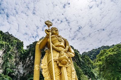 Statue on mountain against sky