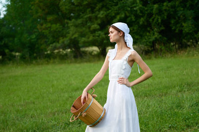 Young woman standing on field