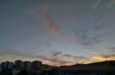 Silhouette cityscape against sky during sunset