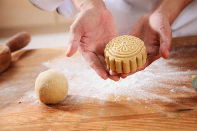 Close-up of person preparing food on cutting board