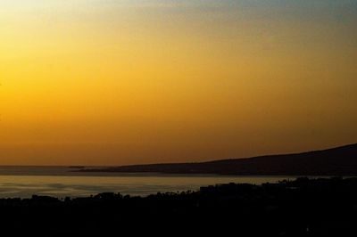 Scenic view of sea against orange sky