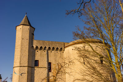 Low angle view of historical building against blue sky