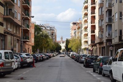 Cars on street amidst buildings in city