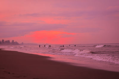 Scenic view of beach against sky during sunset