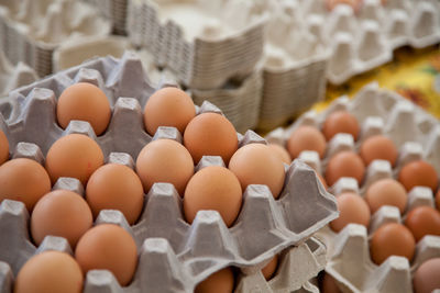 High angle view of eggs in crate at market for sale