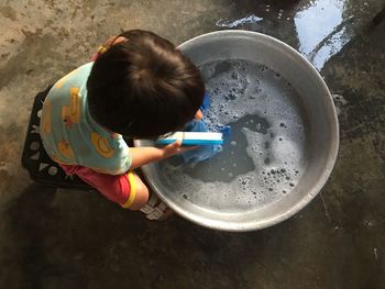 High angle view of girl holding water