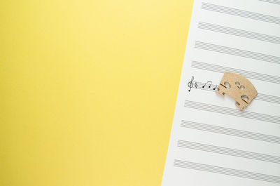 Close-up of sheet music on yellow background