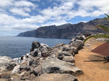 Scenic view of sea and mountains against sky