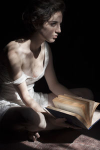 Young woman reading book