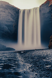 Scenic view of waterfall in sea