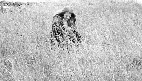 Woman amidst grassy field