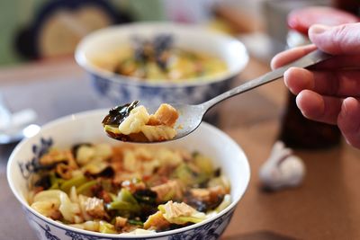 Midsection of person having food on table