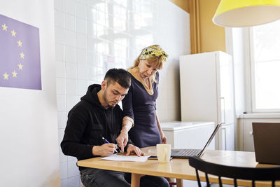 Woman helping young man at job center