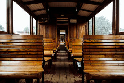 Empty wooden benches in train