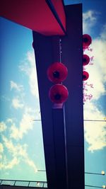 Low angle view of red light against sky